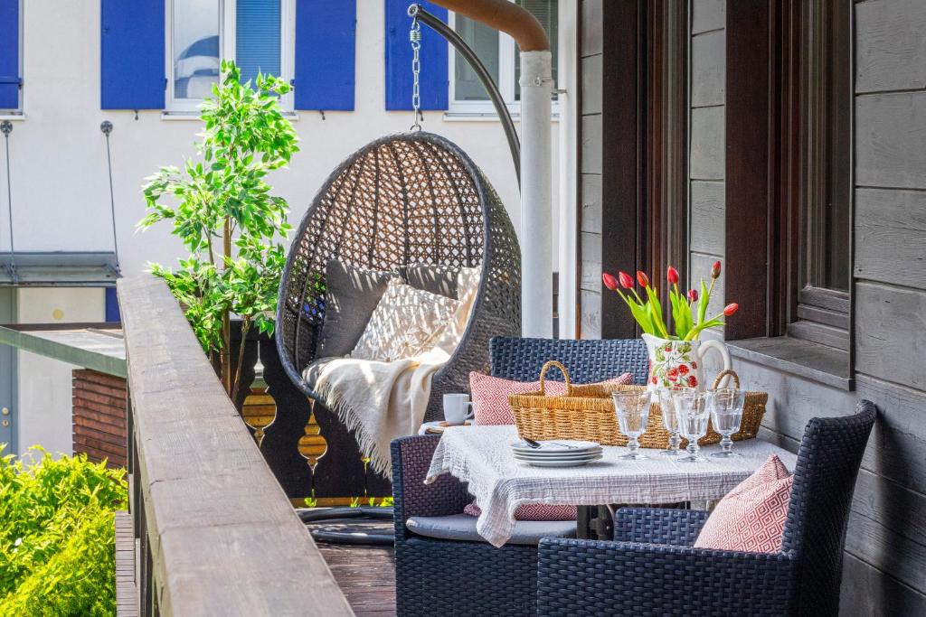 a table and chairs on a balcony with a table and glasses at Suite Werdenfels in Garmisch-Partenkirchen