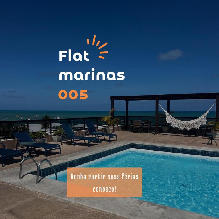 a sign for a hotel with a swimming pool and the ocean at Marinas Praia Flat 005 in João Pessoa