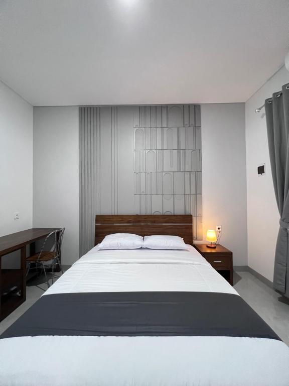 Postel nebo postele na pokoji v ubytování Rauda Living Space Syariah
