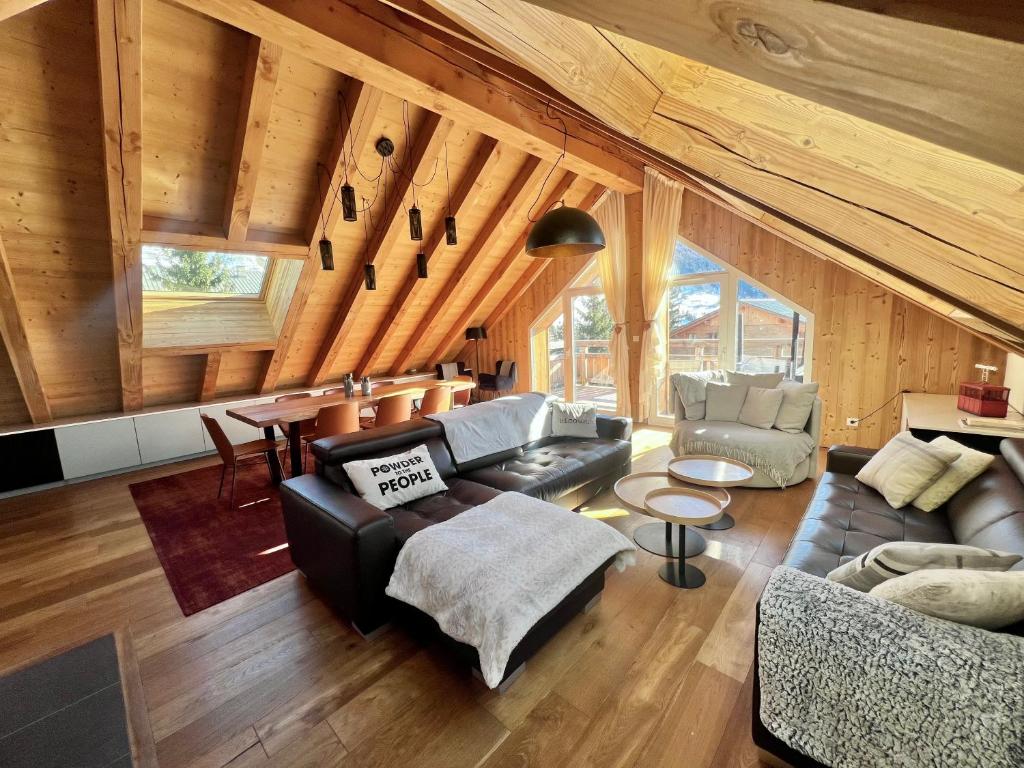 a living room with a couch and a table at Chalet Red Mount - Esprit chalet au pied des pistes in Les Deux Alpes