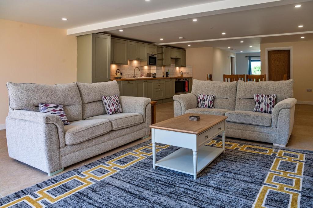 a living room with two couches and a coffee table at Little Rissington - Barn Seven in Little Rissington