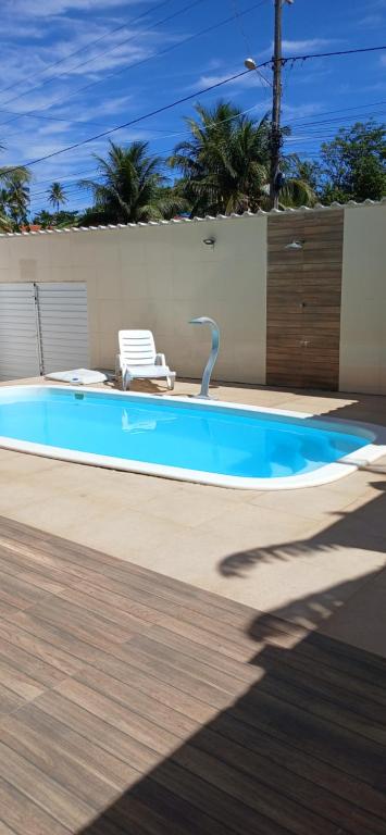 a swimming pool with a faucet in a yard at Casa Jacuipe temporada in Camaçari