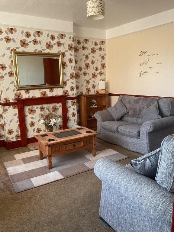 a living room with a couch and a coffee table at Shirleys apartment in Rhyl