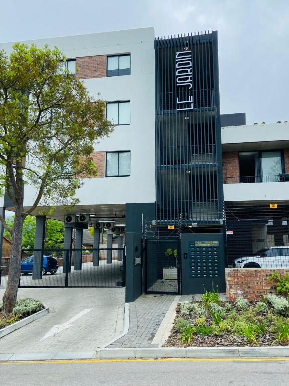 a building with a gate in front of it at Le jardin 211 in George