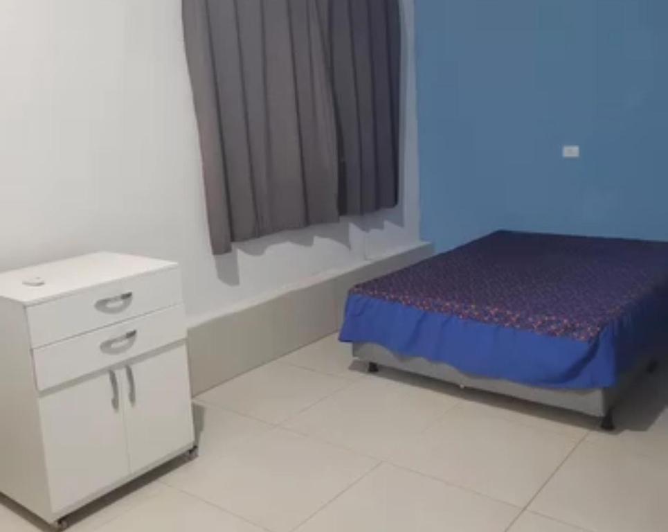 a bedroom with a bed and a dresser and a window at Marina's in Pau dʼAlho