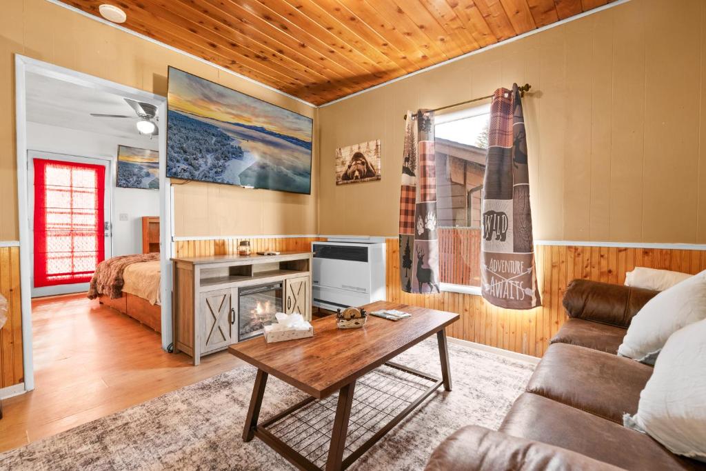 a living room with a couch and a table at Hideaway Cabin - Cozy romantic cabin perfect for couples in Big Bear City