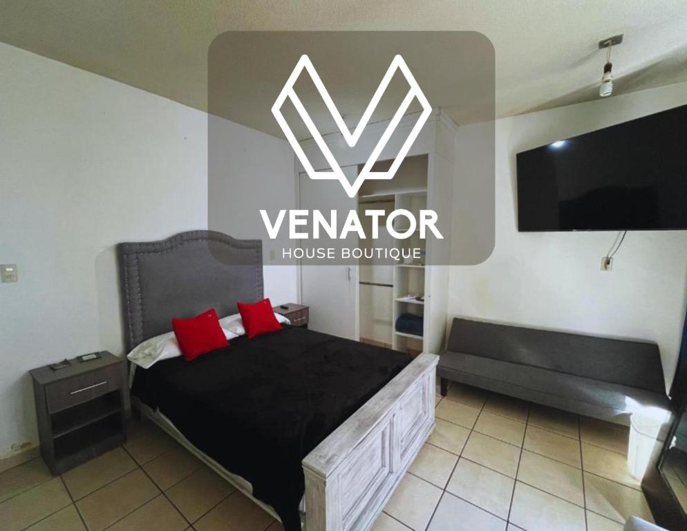 a bedroom with a bed with red pillows and a tv at 10 VENATOR House Boutique in León