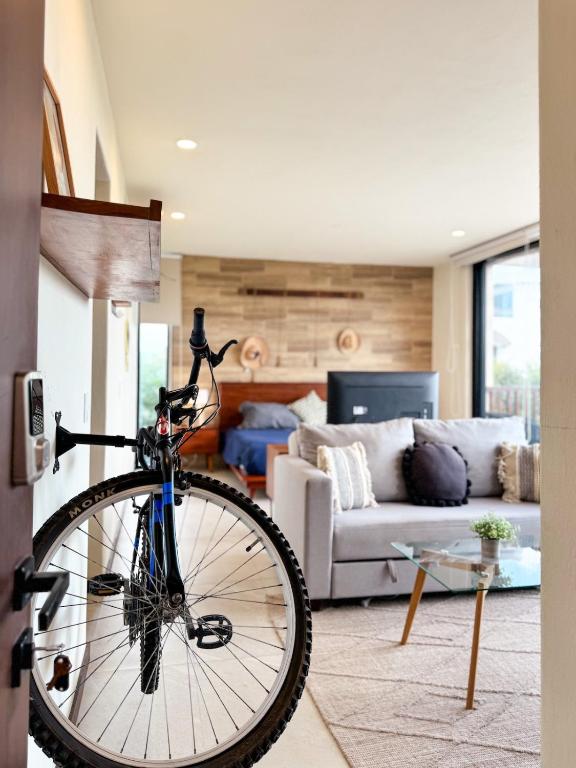 a bike is parked in a living room at BOHO Loft Steps from the Beach in Holbox Island