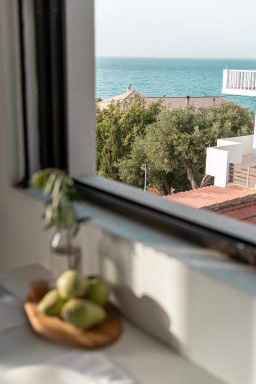 a window with a plate of fruit on a counter at Sea View Studio at Xenios Avlais in Zakynthos Town