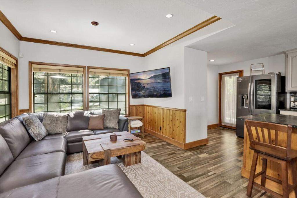 a living room with a couch and a table at Serenity Cove Lake House by Big Bear Vacations in Big Bear Lake