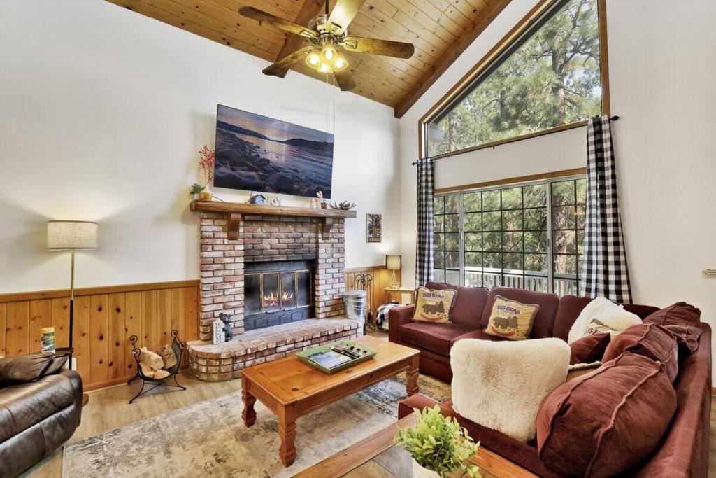 a living room with a couch and a fireplace at Relaxing Four Bears Cabin in Big Bear Lake in Big Bear Lake