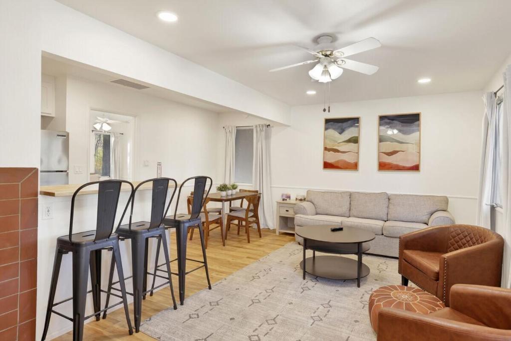 a living room with a couch and a table at Relaxing Woodside Cottage at Shay Meadow Ranch in Big Bear City
