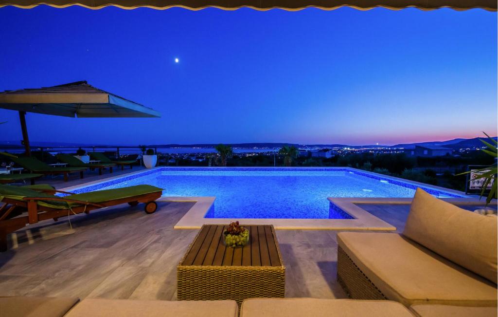 a swimming pool at night with a blue sky at Nice Home In Kastel Stari With Jacuzzi in Kastel Stari
