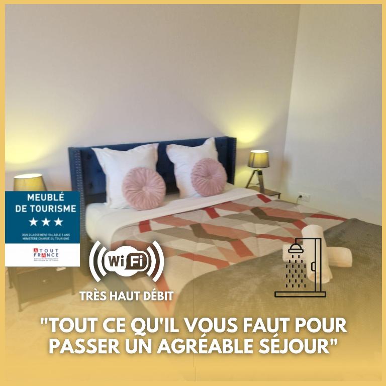 a bedroom with a bed with two pink pillows at Gite de Gabriel in Blois