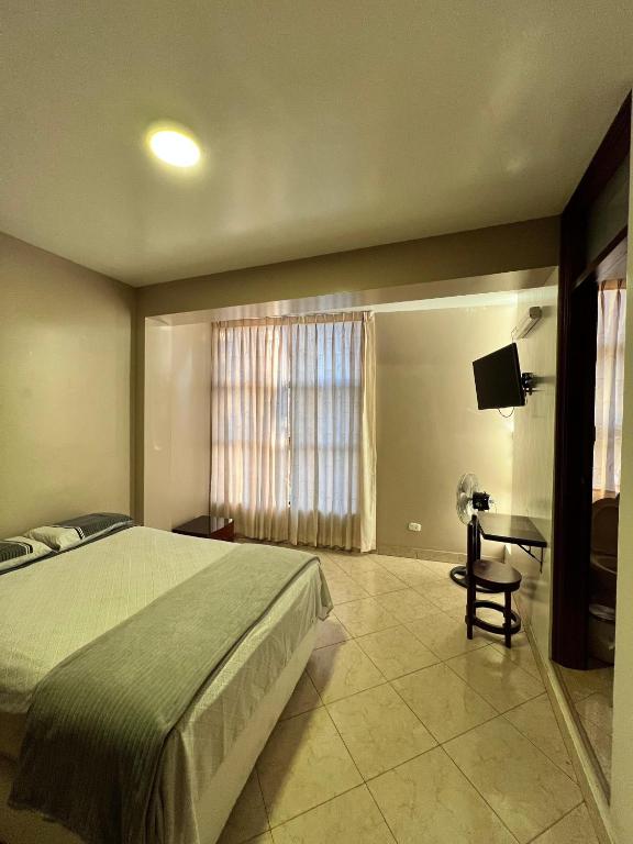 Postel nebo postele na pokoji v ubytování Hostal Borsalino