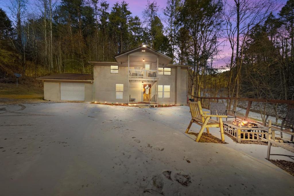 a house with a table and a chair in front of it at Hidden Ranch in Sevierville