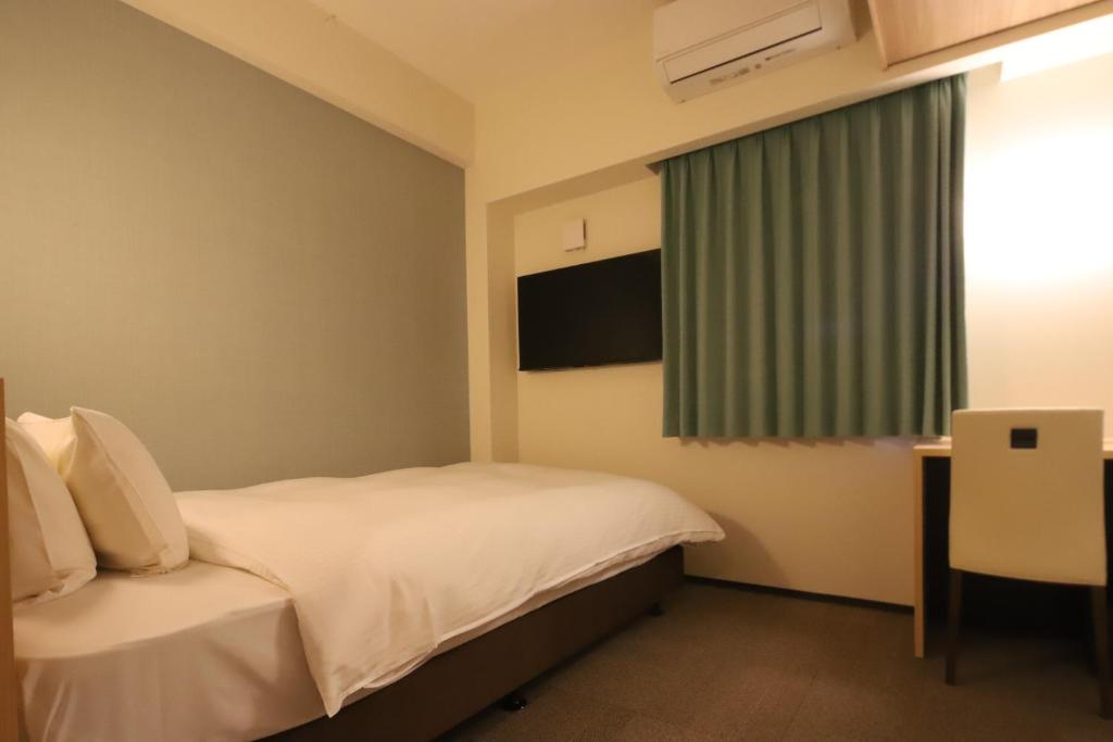 Postel nebo postele na pokoji v ubytování AB Hotel Igaueno