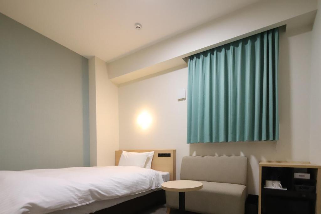 Postel nebo postele na pokoji v ubytování AB Hotel Igaueno