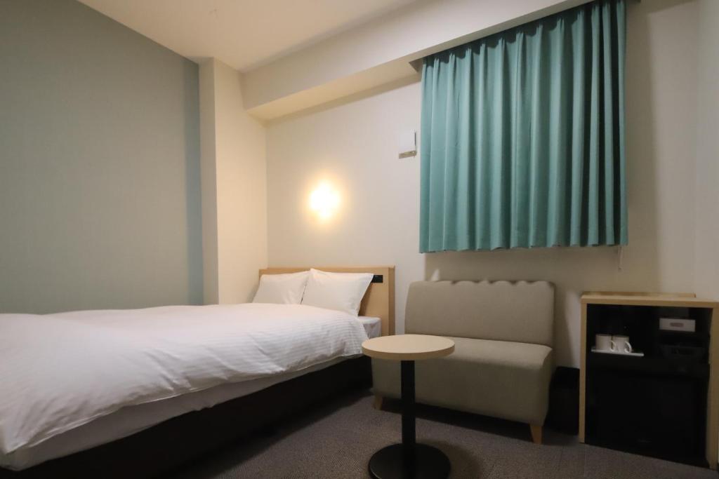 Postel nebo postele na pokoji v ubytování AB Hotel Igaueno