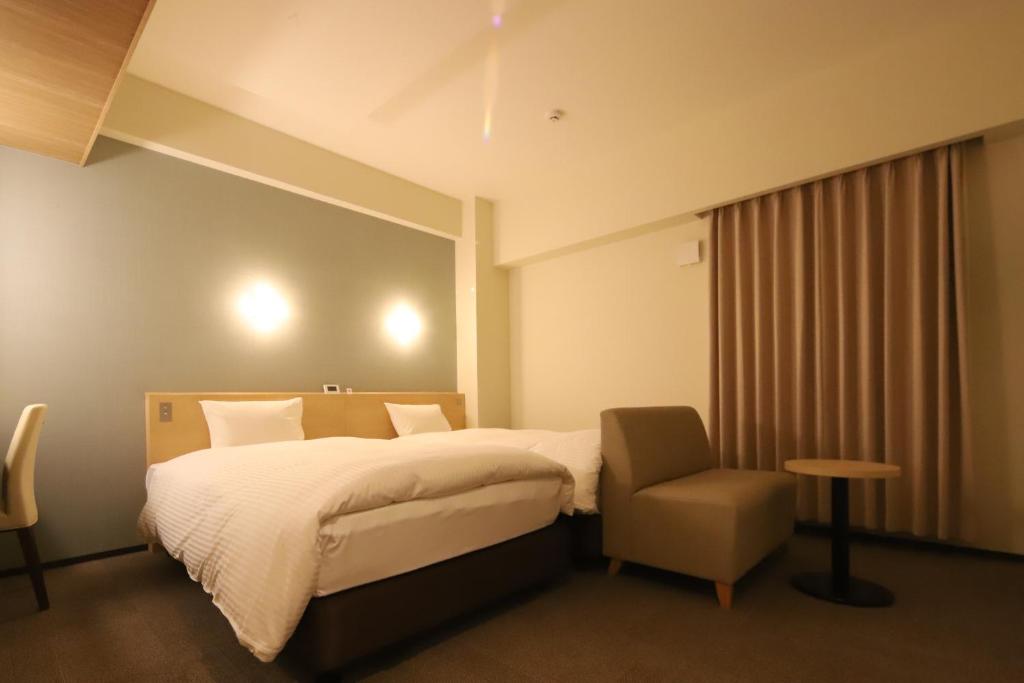 Postel nebo postele na pokoji v ubytování AB Hotel Igaueno