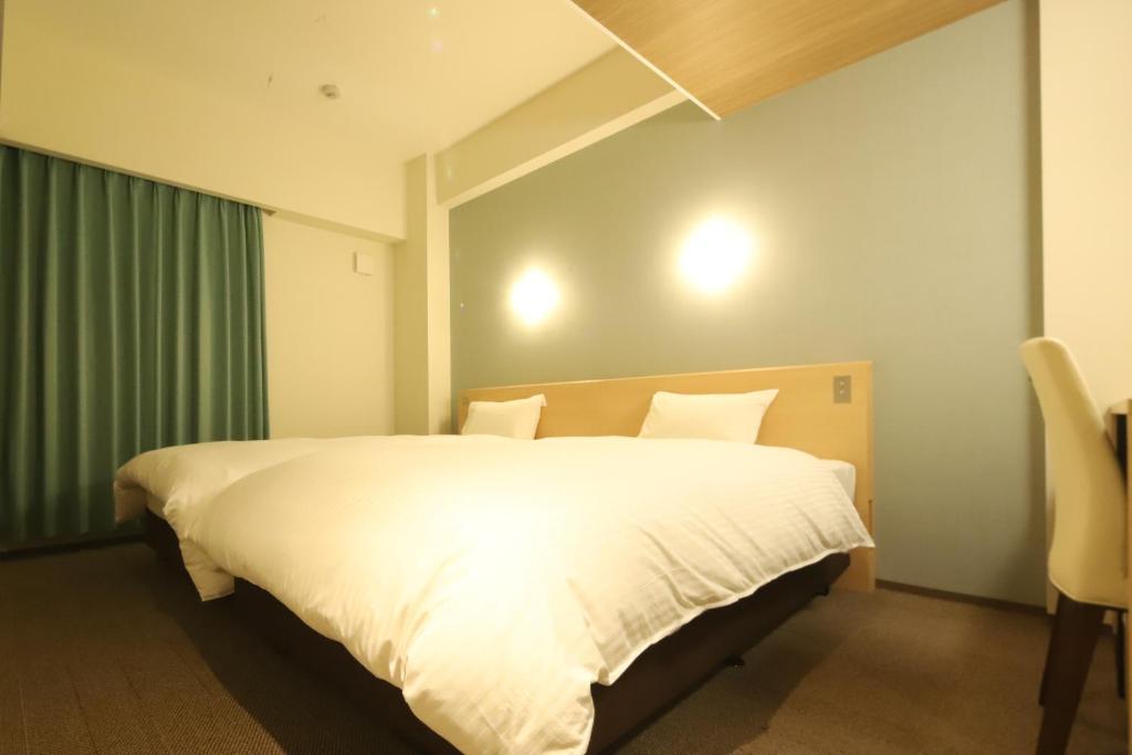 Postel nebo postele na pokoji v ubytování AB Hotel Nakatsugawa