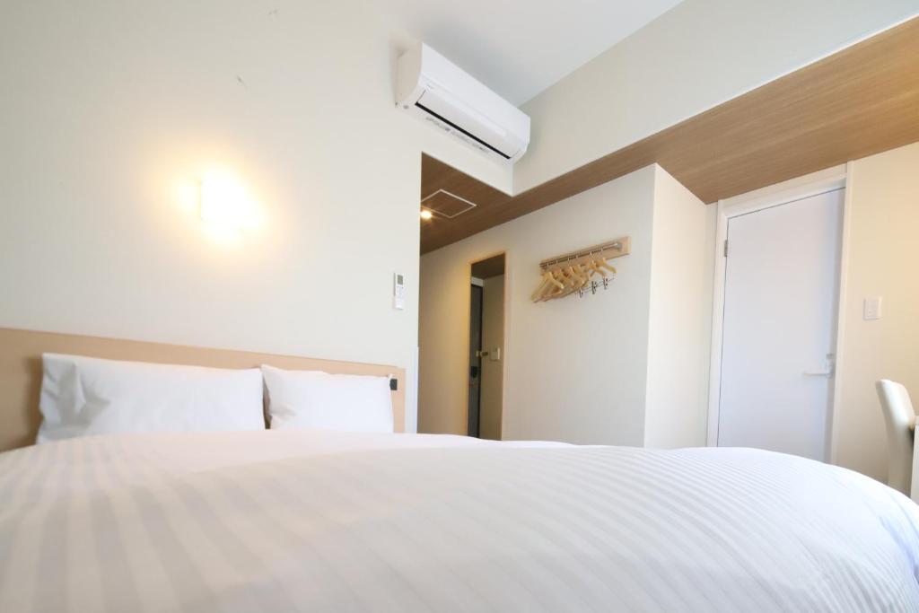 Postel nebo postele na pokoji v ubytování AB Hotel Nakatsugawa