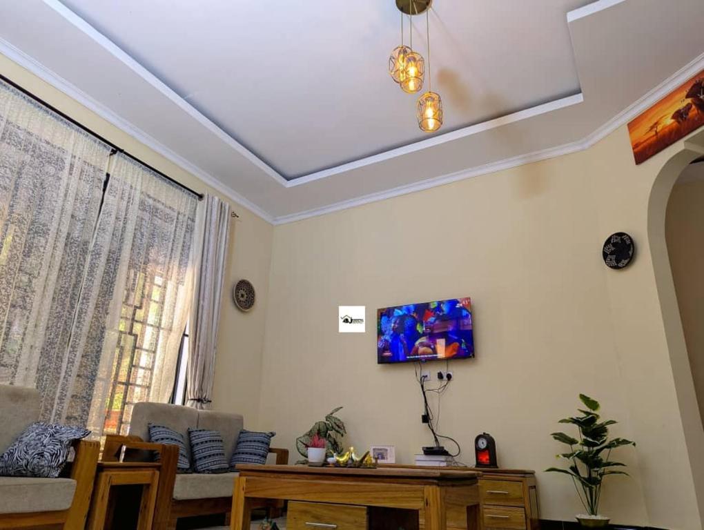 a living room with a coffered ceiling at Jegestal Serenity Homestay Camping and Tours in Lushoto