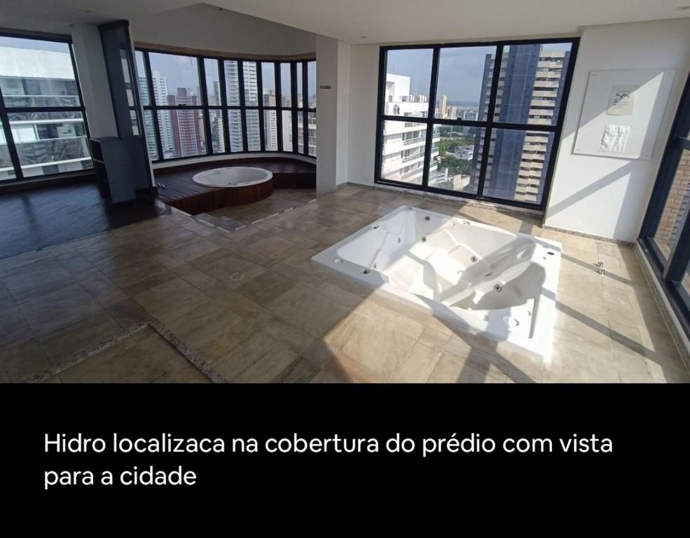 a large room with a tub in the middle of a building at Multiplex Unique DOCA cop30 in Belém