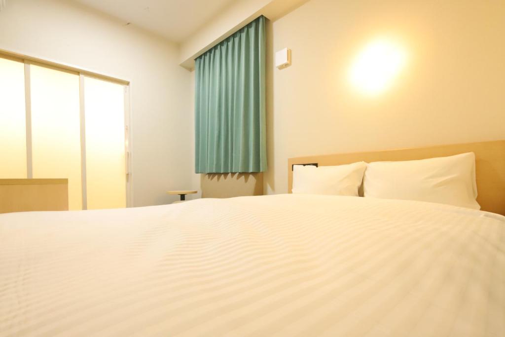 Postel nebo postele na pokoji v ubytování AB Hotel Nakatsugawa