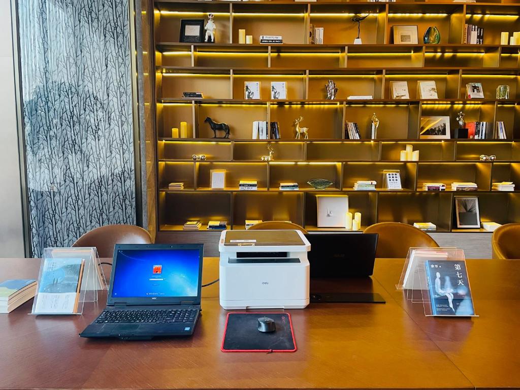 a laptop computer sitting on top of a table at Tianyongge Art Hotel Shanghai Disney Store in Shanghai