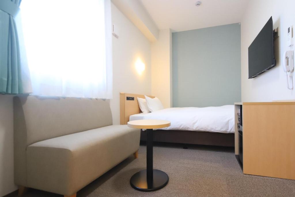 Postel nebo postele na pokoji v ubytování AB Hotel Nakatsugawa
