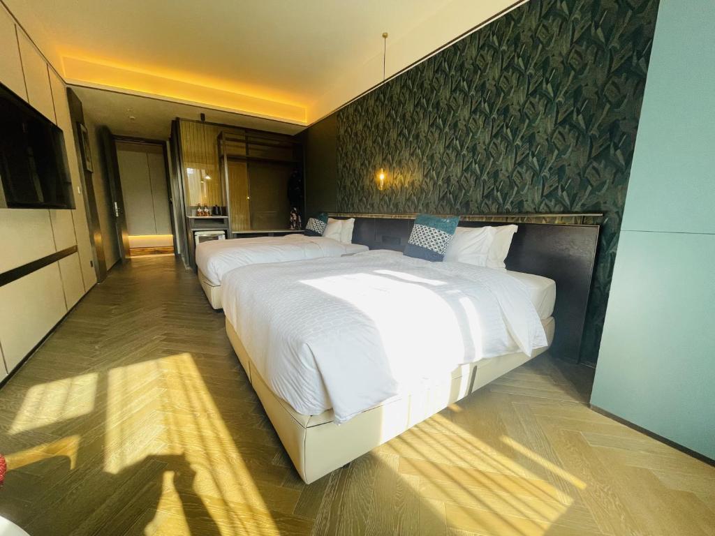 a large bedroom with a large white bed in it at Tianyongge Art Hotel Shanghai Disney Store in Shanghai