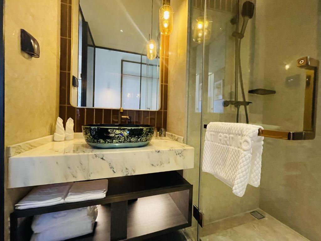 a bathroom with a sink and a mirror at Tianyongge Art Hotel Shanghai Disney Store in Shanghai