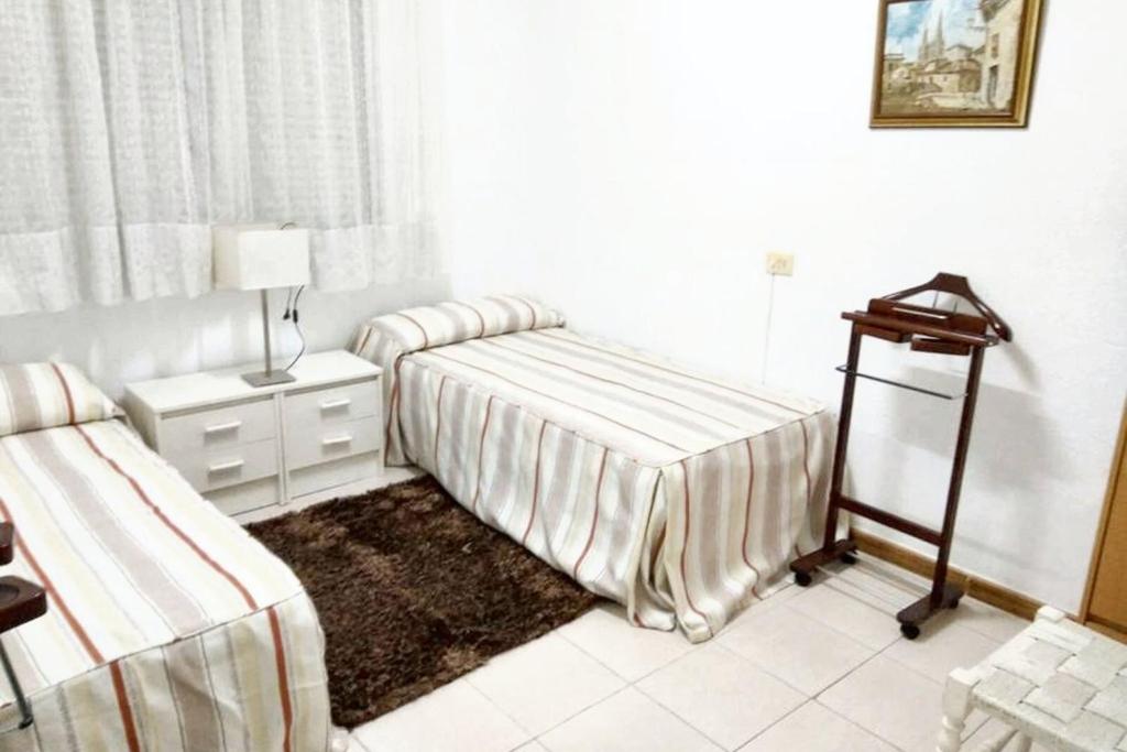 A bed or beds in a room at Welcoming House in Burgos with Terrace and City View