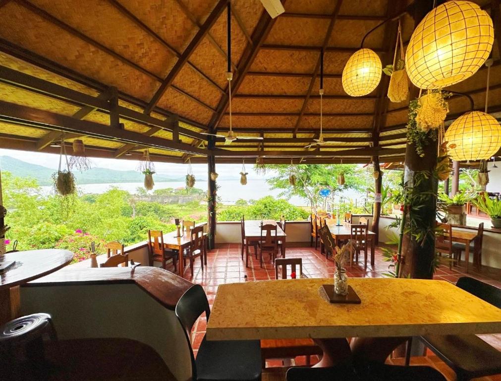 a restaurant with a table and chairs and a view at Casa Rosa Inn and Restaurant in Taytay