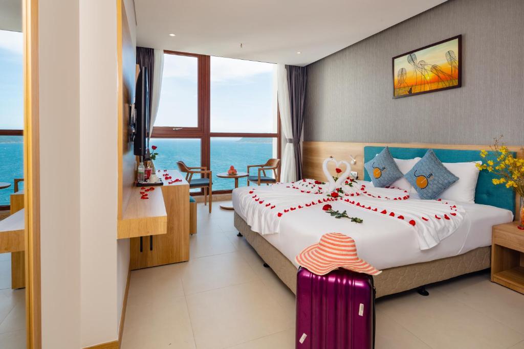 Postel nebo postele na pokoji v ubytování Sun Kiss Hotel