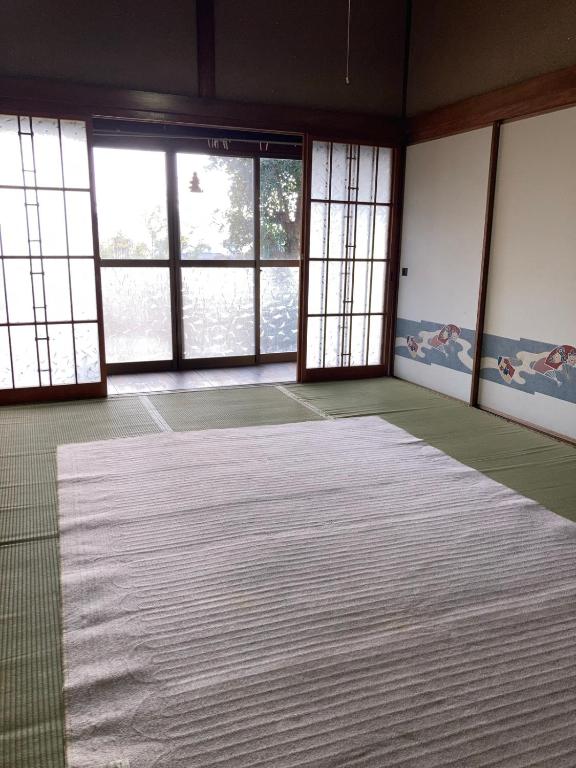 Postel nebo postele na pokoji v ubytování しまなみゲストハウス南風荘