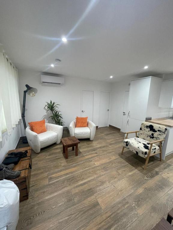 a living room with two couches and a table at Chalet K94 - Sunset View in Camber