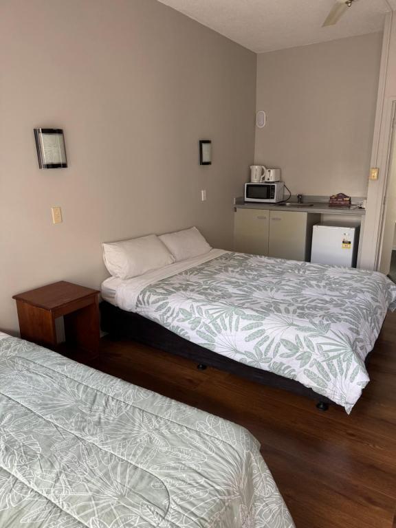 Postel nebo postele na pokoji v ubytování Mt Wellington Motel