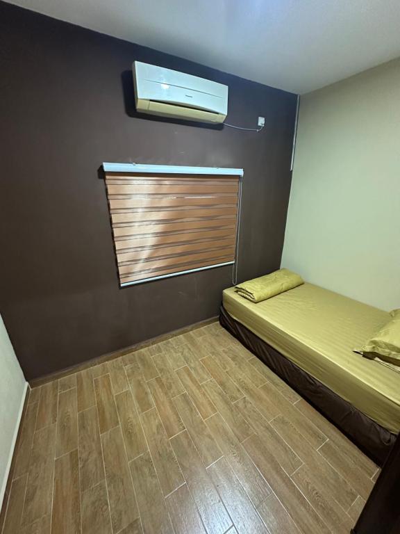 a small room with a bed and a window at Santai Salai Homestay and Cafe in Kepala Batas