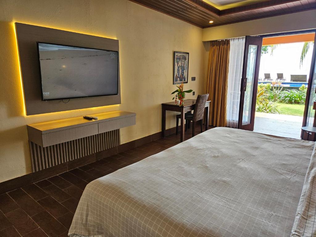Postel nebo postele na pokoji v ubytování Sunsethouse Lombok
