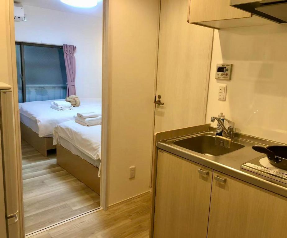 Postel nebo postele na pokoji v ubytování KOSUMOSU Ikebukuro Shinjuku Private House