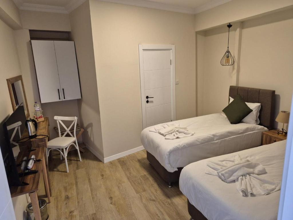 Postel nebo postele na pokoji v ubytování PRUVA İNN HoTEL