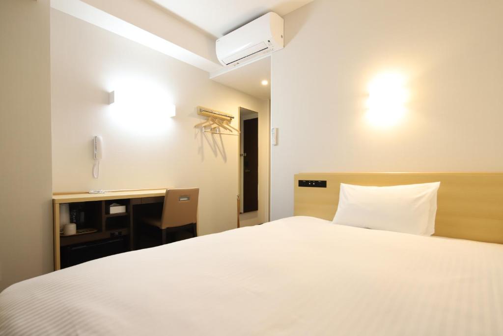 Postel nebo postele na pokoji v ubytování AB Hotel Konan