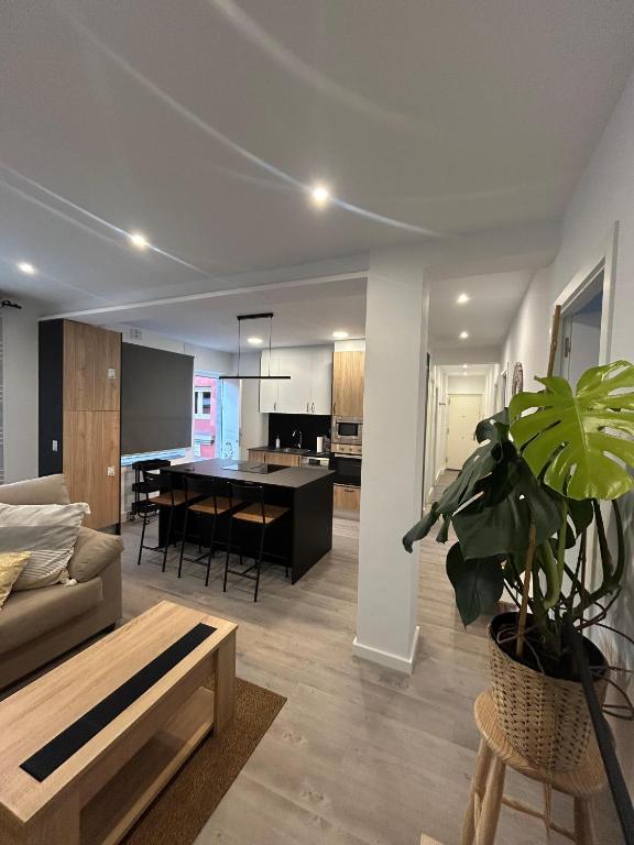 a living room with a couch and a table at Apartamento de la playa VUT 7012 AS in San Juan de Nieva