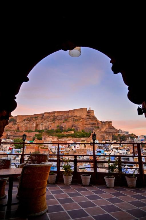 a view of the acropolis from a building with a table and chairs at Castle View Heritage Haveli in Jodhpur