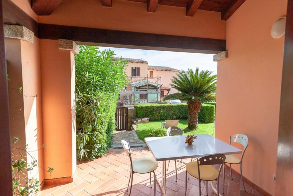 a patio with a white table and chairs at Villetta Perla Marina 2 in San Teodoro