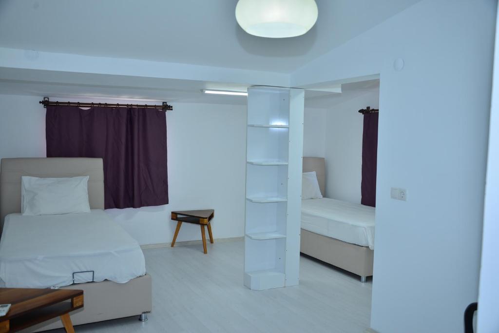 Postel nebo postele na pokoji v ubytování Aquarius Hotel