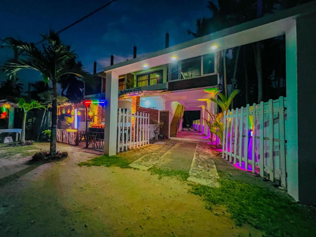 a house with colorful lights on the side of it at Ocean Wave Hikakduwa in Hikkaduwa
