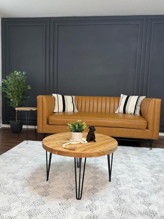 a living room with a couch and a coffee table at The Cozy Haven in Owasso